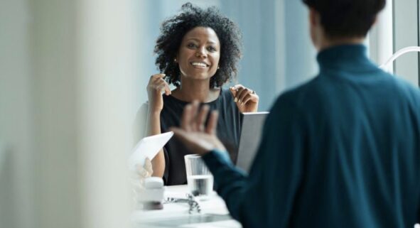 Two people talking and working together