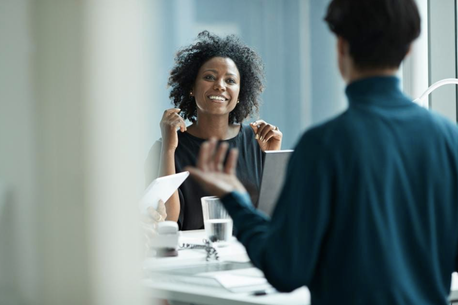 Two people talking and working together